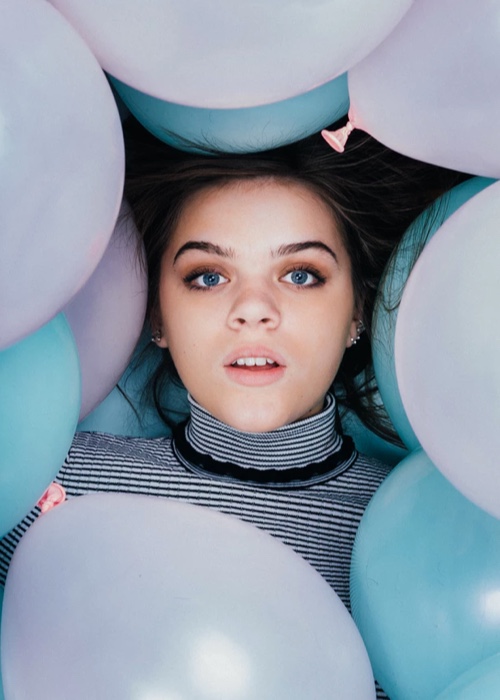 woman surrounded by blue and pink balloon